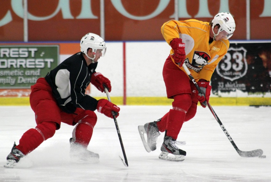 Danny Biega and Kyle Bonis participate in a drill at Charlotte Checkers training camp. (Photo - J. Propst)